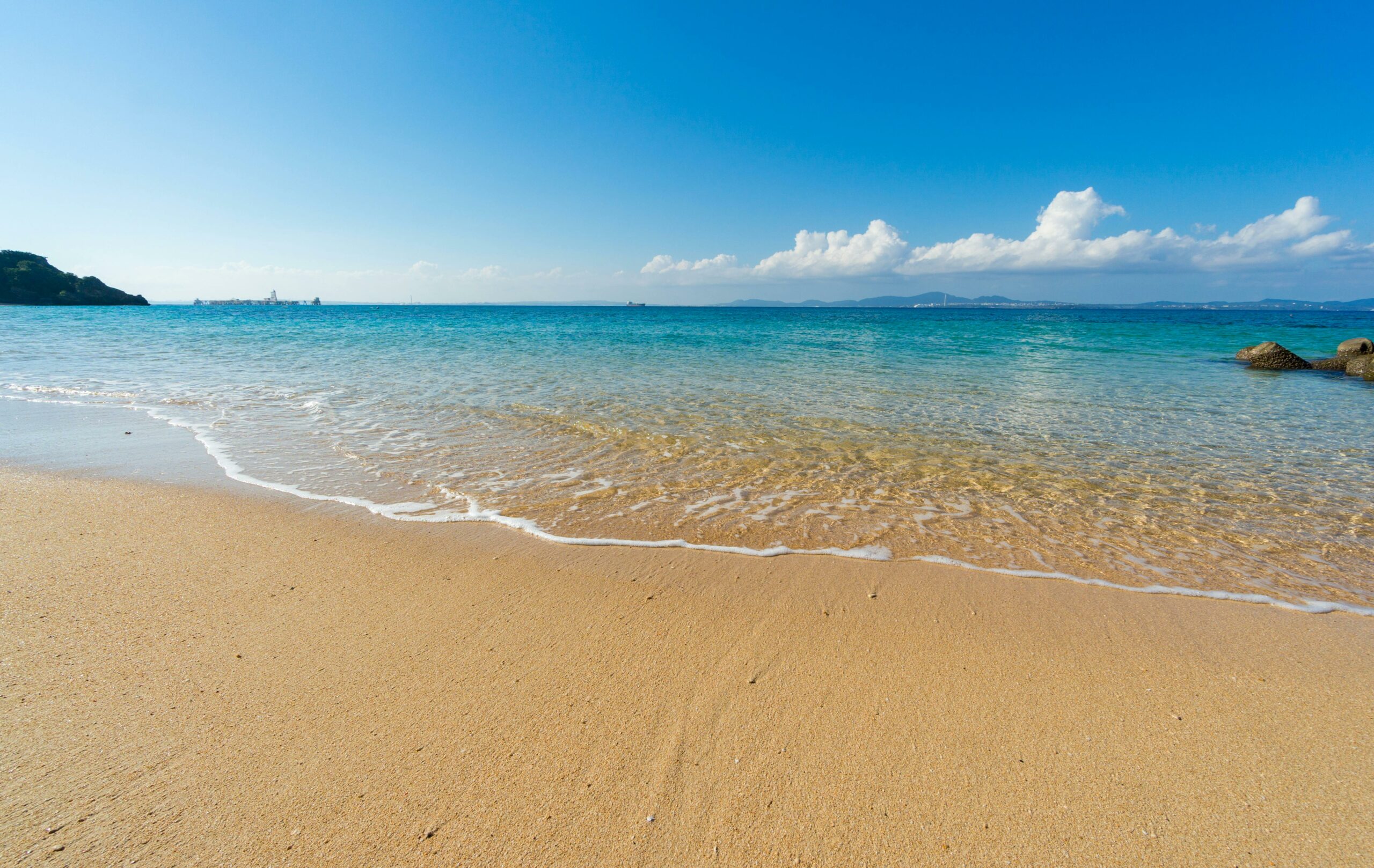 sand beach with crystal water with blue sky