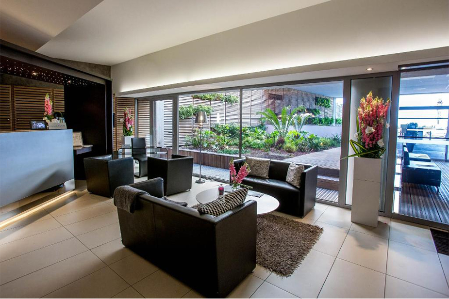 Hotel Royal Antibes reception area featuring contemporary décor, comfortable lounge chairs, and bright natural light.